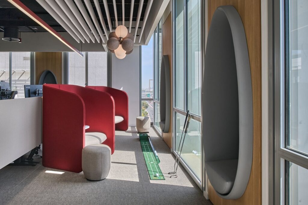 Modern relaxing pod with soft lighting and comfortable seating, designed as a calm breakout space in a workplace interior fit-out.