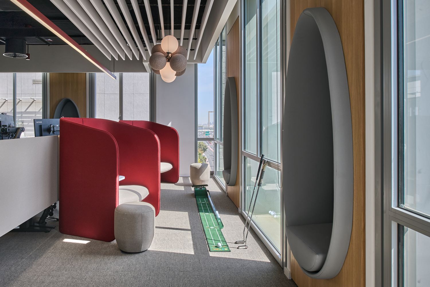 Modern relaxing pod with soft lighting and comfortable seating, designed as a calm breakout space in a workplace interior fit-out.