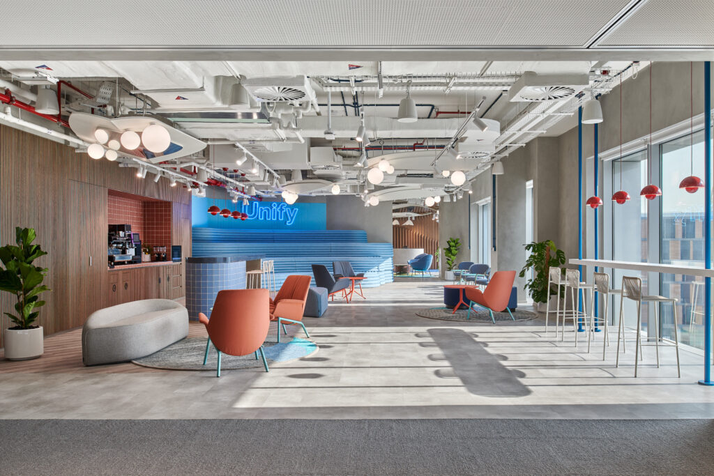 Vibrant open-plan workspace by Summertown Interiors for Sprinkle, featuring sustainable fit-out, biophilic elements, flexible seating, and abundant natural light. Bold colours, modern furnishings, and ergonomic zones support collaboration and wellbeing.
