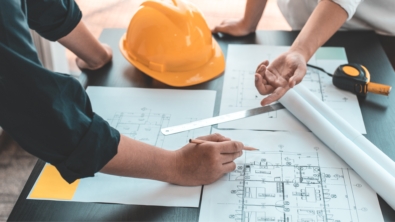 Team reviewing office floor plans to avoid common layout mistakes and apply sustainable fit-out solutions