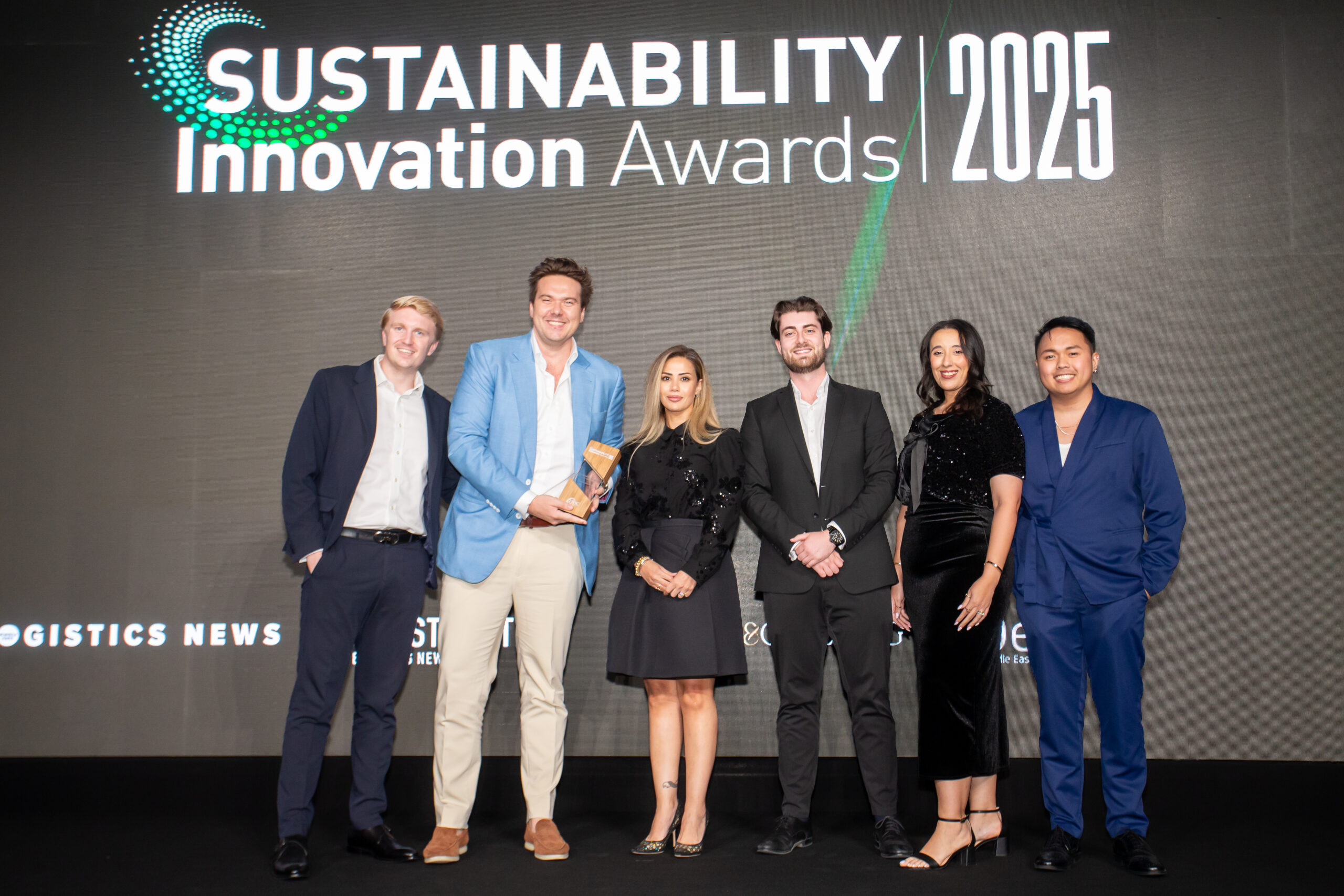 Summertown Interiors team on stage receiving the Sustainable Fit-Out Firm of the Year award at the Sustainability Innovation Awards 2025 in Dubai.
