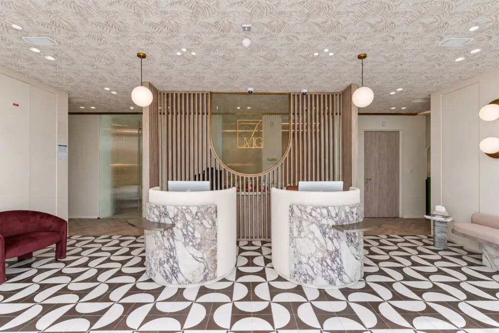 Twin marble reception desks at The Spierings Medical Group clinic in Dubai Hills, fitted out by Summertown