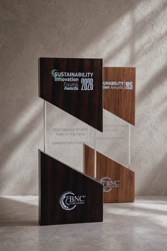 Summertown Interiors' 2025 and 2026 Sustainable Fit-Out Firm of the Year trophies side by side